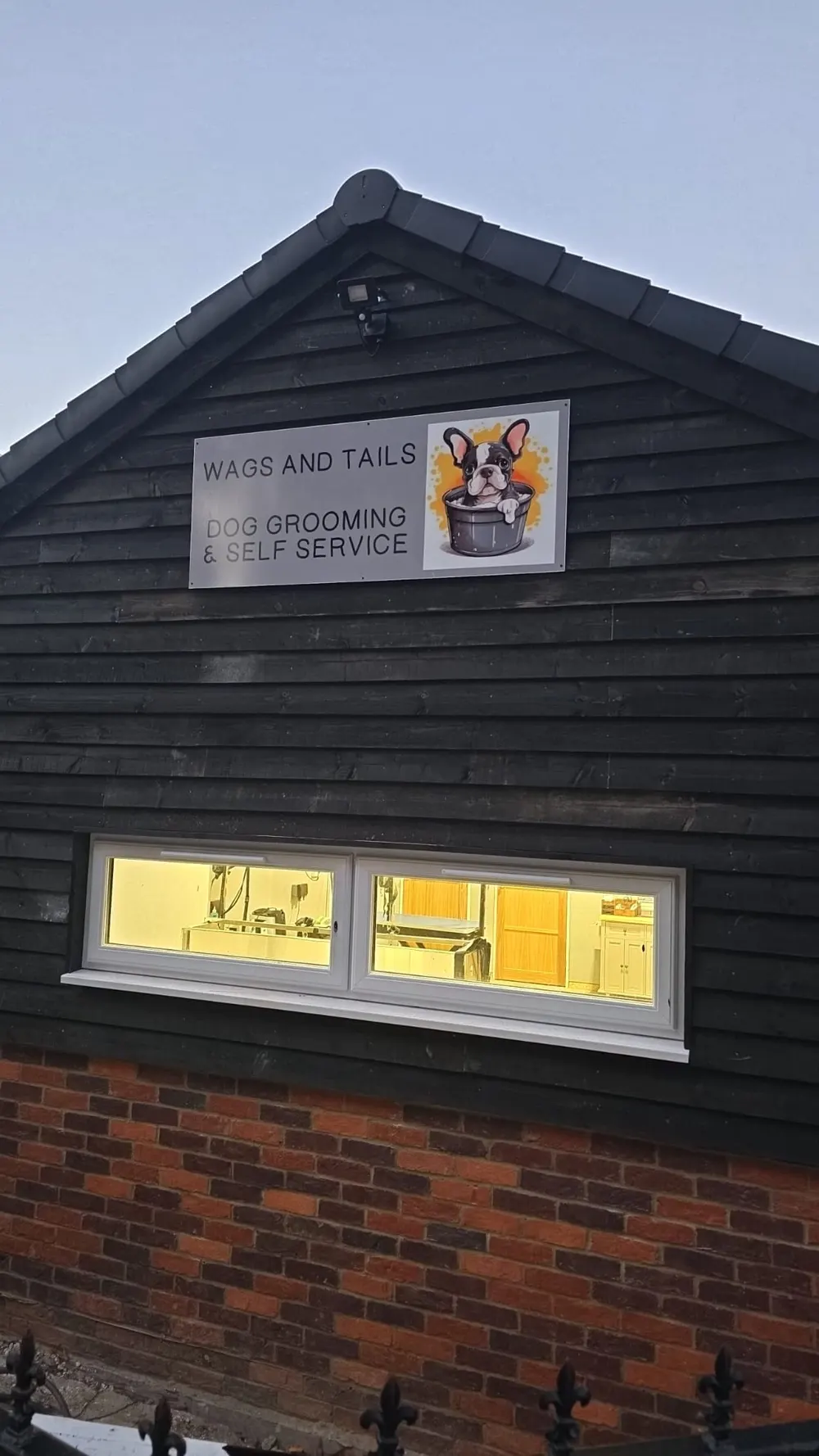 The outside of the Wags and Tails salon with its sign